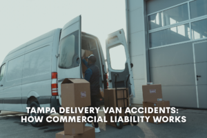 delivery truck driver loads boxes into back of delivery van